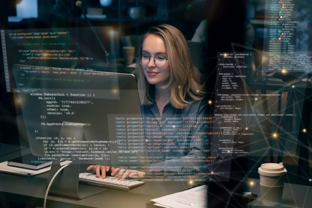 Woman coding with data and code screens in a tech environment