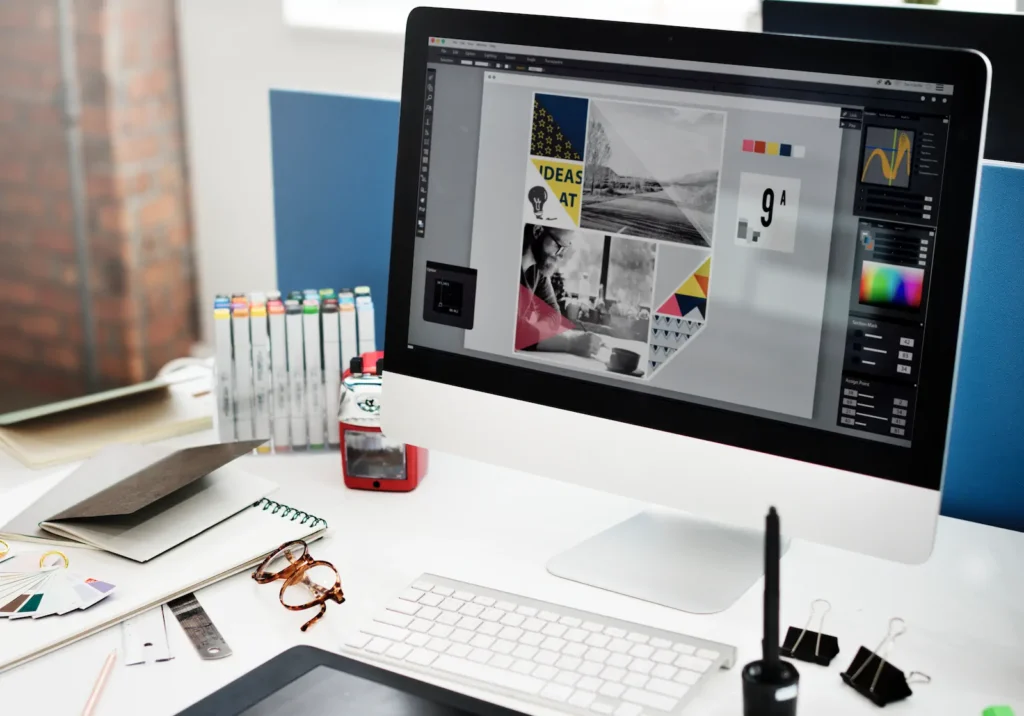 Monitor with graphic design and website layout software.