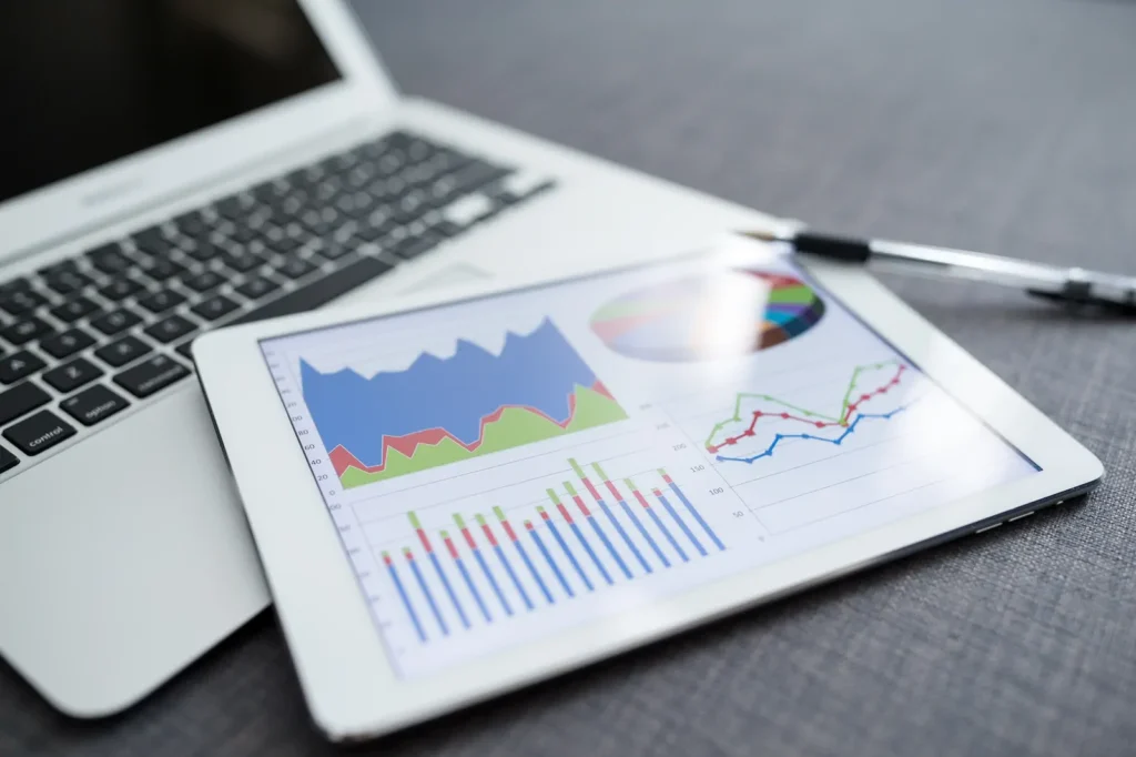 Tablet and laptop showing SEO performance graphs and statistics.