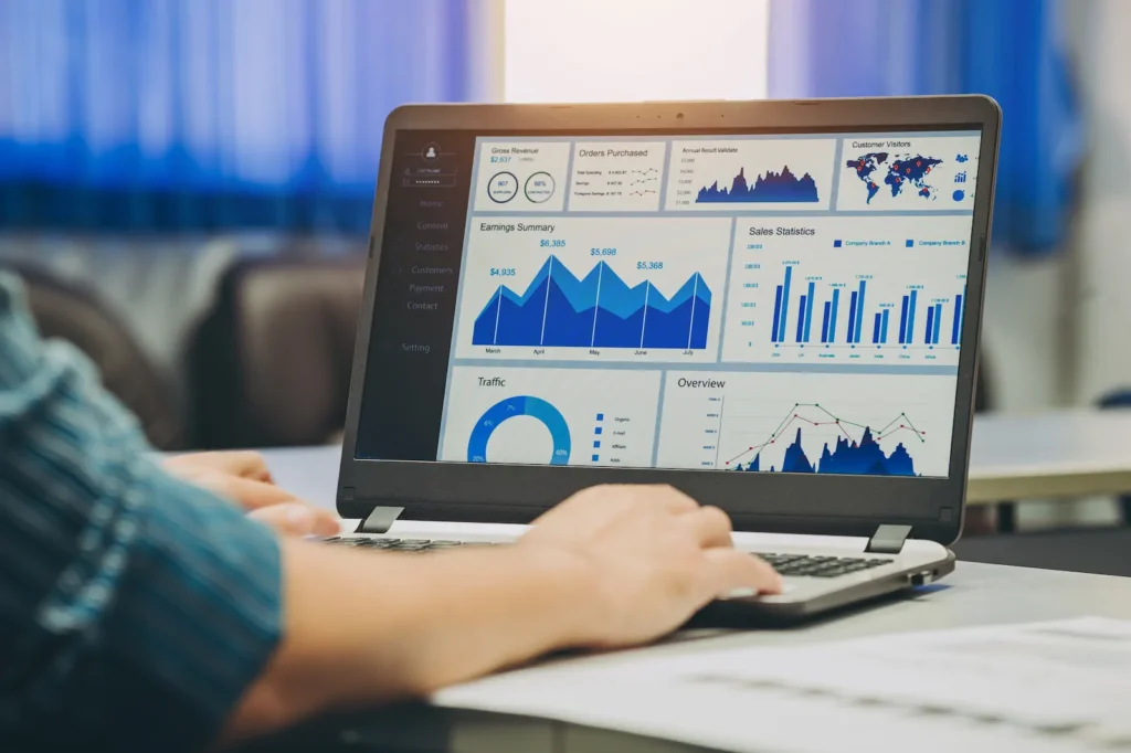 Laptop with SEO metric dashboards and web traffic analysis.