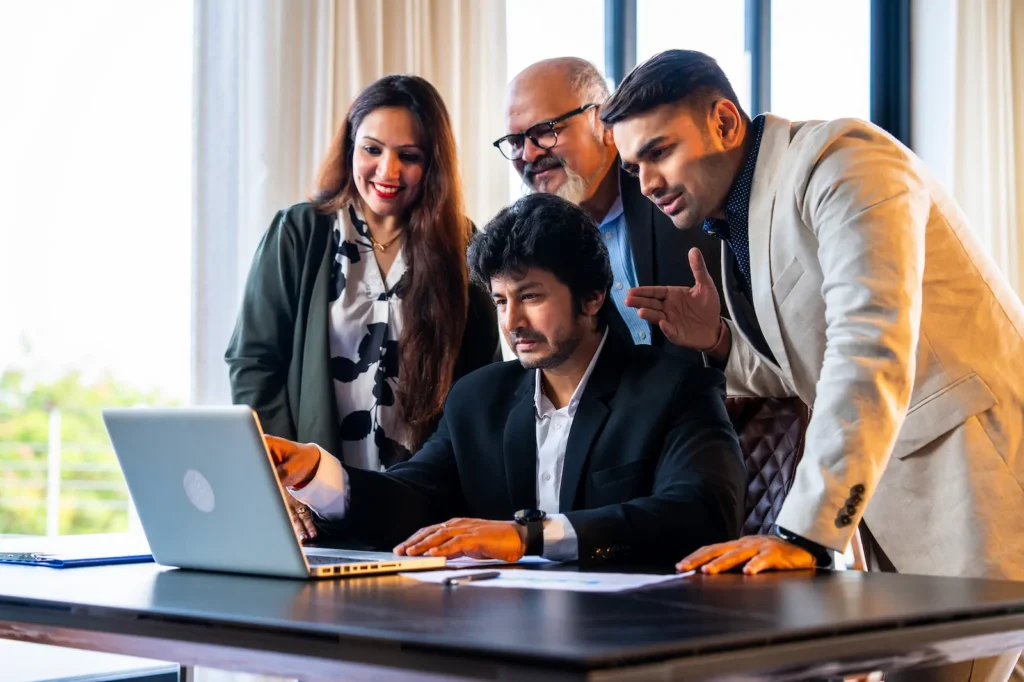 Team of professionals analyzing SEO strategies on a laptop.