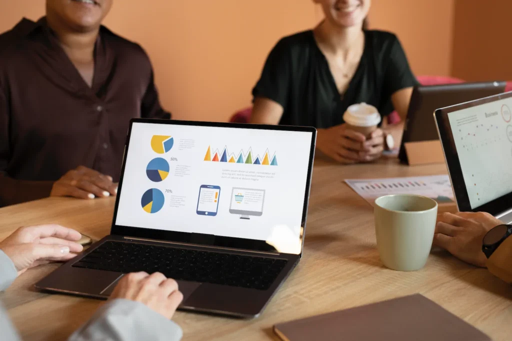 Team reviewing digital metrics on a laptop to optimize business results